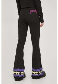 Local Heroes spodnie damskie kolor czarny dzwony high waist. Stan: podwyższony. Kolor: czarny. Wzór: nadruk