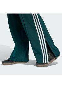 Adidas - adidas Spodnie dresowe Firebird KG3701 Zielony Loose Fit. Kolor: zielony. Materiał: syntetyk #3