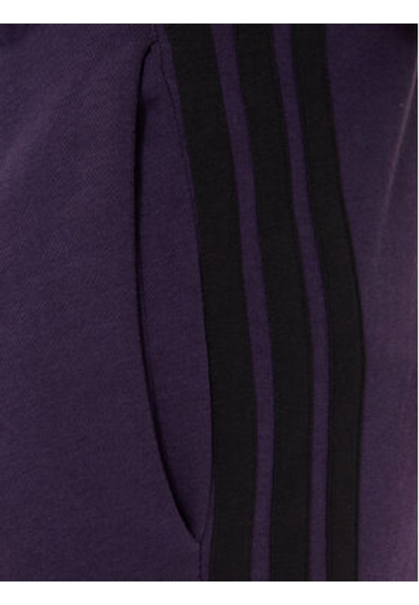 Adidas - adidas Spodnie dresowe Essentials 3-Stripes JX0750 Fioletowy Regular Fit. Kolor: fioletowy. Materiał: bawełna