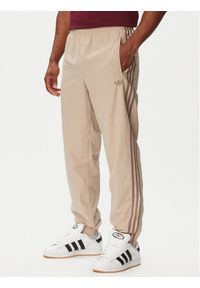 Adidas - adidas Spodnie dresowe Firebird KS7503 Beżowy Regular Fit. Kolor: beżowy. Materiał: syntetyk #1