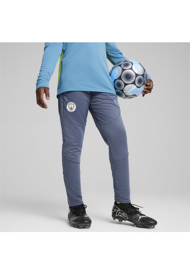 Puma - Młodzieżowe spodnie treningowe Manchester City PUMA Inky Blue Magic. Kolor: niebieski. Materiał: dresówka. Sport: piłka nożna