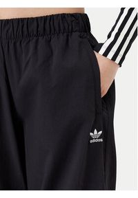 Adidas - adidas Spodnie dresowe Essentials Ripstop JD0785 Czarny Loose Fit. Kolor: czarny. Materiał: syntetyk #3