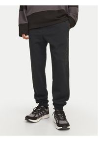 Jack & Jones - Jack&Jones Spodnie dresowe Gordon 12258477 Czarny Regular Fit. Kolor: czarny. Materiał: syntetyk, bawełna