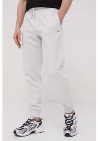 Tommy Jeans Spodnie męskie kolor szary gładkie. Kolor: szary. Materiał: dzianina, bawełna. Wzór: gładki