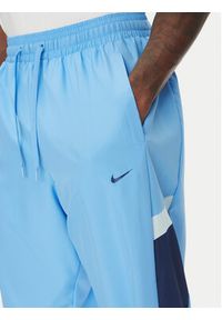 Nike Spodnie dresowe Icon FZ0250 Niebieski Relaxed Fit. Kolor: niebieski. Materiał: syntetyk
