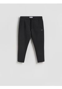 Reserved - Spodnie dresowe slim - czarny. Kolor: czarny. Materiał: dresówka #1