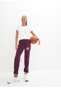 bonprix - Spodnie dresowe z elastycznego materiału z bawełną. Kolor: fioletowy. Materiał: dresówka, bawełna, materiał. Wzór: nadruk. Styl: sportowy #3