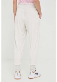 Adidas - adidas spodnie dresowe damskie kolor beżowy. Kolor: beżowy. Materiał: dresówka #3