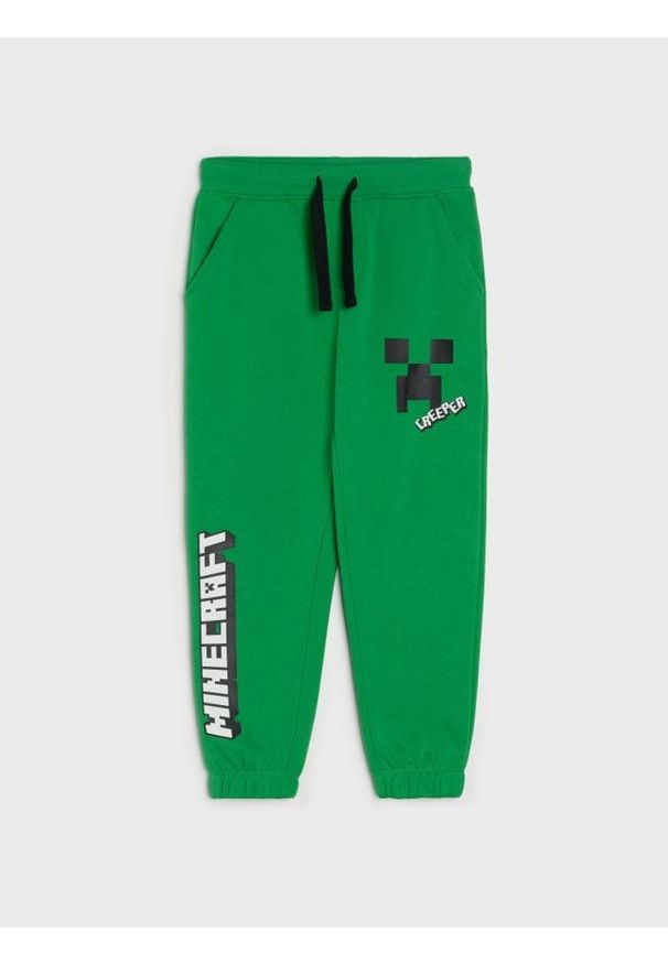Sinsay - Spodnie dresowe jogger z nadrukiem Minecraft - zielony. Kolor: zielony. Materiał: dresówka. Wzór: nadruk