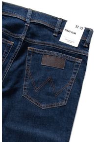 Wrangler - WRANGLER TEXAS SLIM MĘSKIE SPODNIE JEANSOWE CROSS GAME W12S8311U. Stan: podwyższony