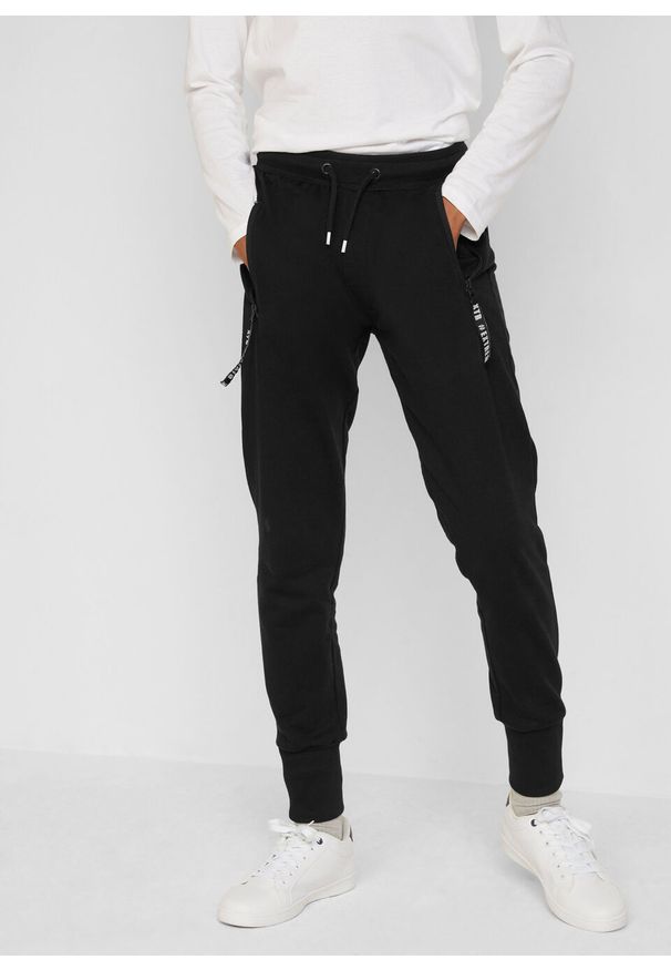 Spodnie dresowe chłopięce z bawełny organicznej bonprix czarny. Kolor: czarny. Materiał: bawełna, dresówka. Styl: sportowy