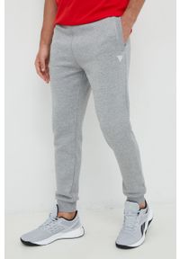 Guess spodnie dresowe kolor szary melanżowe. Kolor: szary. Materiał: dresówka. Wzór: melanż #3