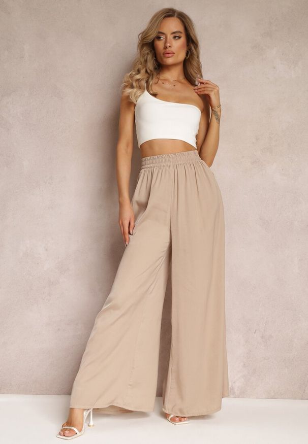Renee - Beżowe Szerokie Spodnie z Gumką w Talii Carleny. Kolor: beżowy. Materiał: tkanina, wiskoza