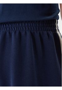 Adidas - adidas Spodnie dresowe adicolor Spacer Track KD4087 Granatowy Baggy Fit. Kolor: niebieski. Materiał: syntetyk. Sport: turystyka piesza #4