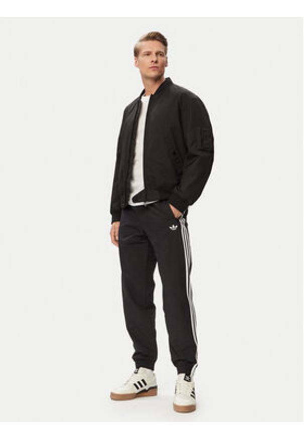 Adidas - adidas Spodnie dresowe Firebird Woven KE1371 Czarny Regular Fit. Kolor: czarny. Materiał: syntetyk
