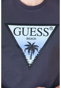 Guess - GUESS Grafitowy t-shirt męski z logo z palmą. Kolor: szary. Wzór: nadruk