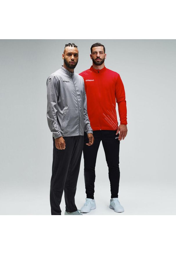 UHLSPORT - Dziecięca bluza dresowa Uhlsport Score 26 Evo. Kolor: wielokolorowy, niebieski, biały. Materiał: dresówka. Wzór: nadruk. Sport: piłka nożna