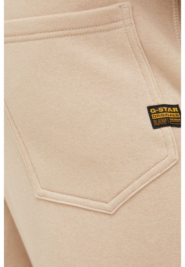 G-Star RAW - G-Star Raw spodnie męskie gładkie. Kolor: beżowy. Materiał: poliester. Wzór: gładki