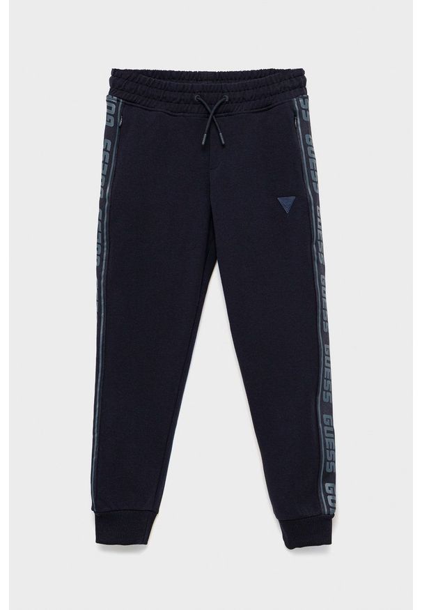 Guess spodnie dresowe dziecięce kolor granatowy z aplikacją. Okazja: na co dzień. Kolor: niebieski. Materiał: dresówka. Wzór: aplikacja. Styl: casual