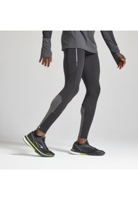 KIPRUN - Legginsy do biegania męskie Kiprun Warm ocieplane. Kolor: czarny, wielokolorowy, szary, żółty. Materiał: elastan, poliester, materiał. Sport: bieganie, fitness