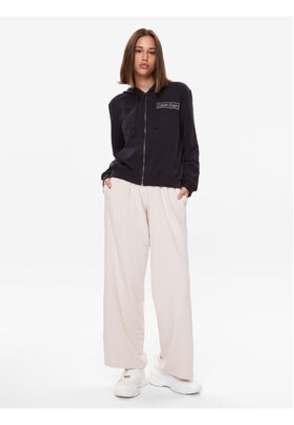 TOMMY HILFIGER - Tommy Hilfiger Spodnie dresowe UW0UW04771 Beżowy Relaxed Fit. Kolor: beżowy. Materiał: dresówka