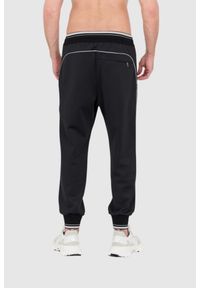 Dolce and Gabbana - DOLCE & GABBANA Czarne spodnie dresowe z dużym logo. Kolor: czarny. Materiał: poliester #3