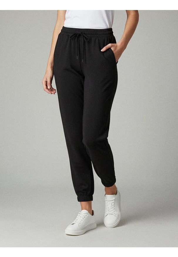 Sinsay - Spodnie dresowe - czarny. Kolor: czarny. Materiał: dresówka