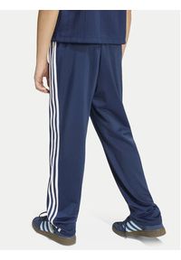Adidas - adidas Spodnie dresowe Firebird HZ6650 Granatowy Regular Fit. Kolor: niebieski. Materiał: syntetyk #5