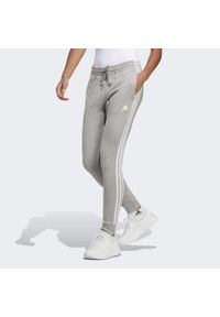 Adidas - Essentials 3-Stripes French Terry Cuffed Pants. Kolor: szary, biały, wielokolorowy. Materiał: materiał. Sport: fitness