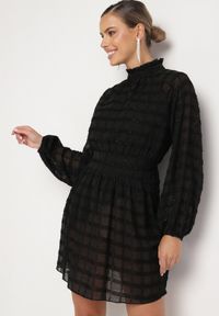 Born2be - Czarna Połyskująca Sukienka o Rozkloszowanym Kroju ze Stójką i Elastyczną Gumką w Pasie Venaraelle. Typ kołnierza: kołnierzyk stójkowy. Kolor: czarny. Wzór: aplikacja. Typ sukienki: rozkloszowane. Styl: klasyczny #3