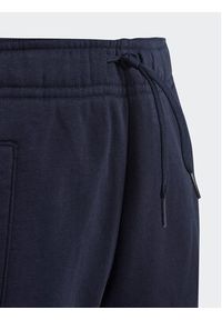 Adidas - adidas Spodnie dresowe Essentials 3-Stripes IC6128 Granatowy Slim Fit. Kolor: niebieski. Materiał: bawełna #4