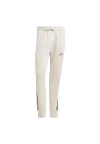 Adidas - Essentials French Terry Tapered Cuff 3-Stripes Pants. Kolor: zielony, wielokolorowy, szary. Materiał: dresówka