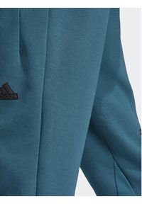 Adidas - adidas Spodnie dresowe IN5100 Turkusowy Regular Fit. Kolor: turkusowy. Materiał: bawełna