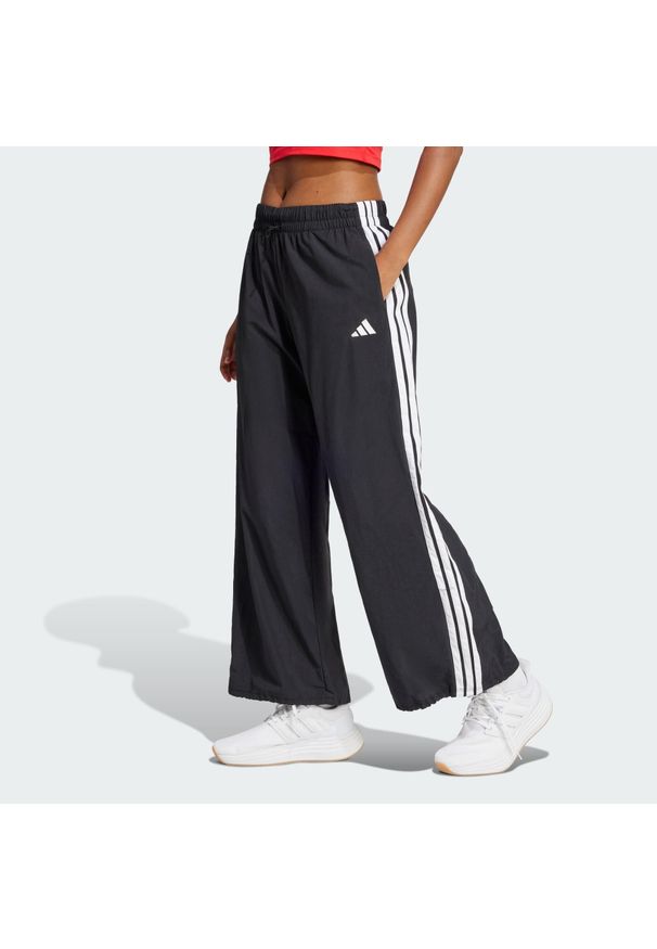 Adidas - Spodnie Essentials 3-Stripes Lifestyle Woven Parachute. Kolor: czarny, biały, wielokolorowy. Materiał: materiał
