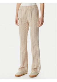 Lacoste Spodnie dresowe XF9313 Beżowy jasny Regular Fit. Kolor: beżowy. Materiał: syntetyk #1