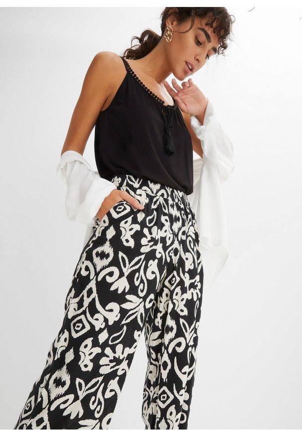 bonprix - Spodnie Marlena z nadrukiem, z lejącej wiskozy. Kolor: czarny. Materiał: wiskoza. Wzór: nadruk