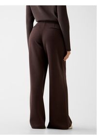 Guess Spodnie materiałowe 166071 Brązowy Slim Fit. Kolor: brązowy. Materiał: materiał #3