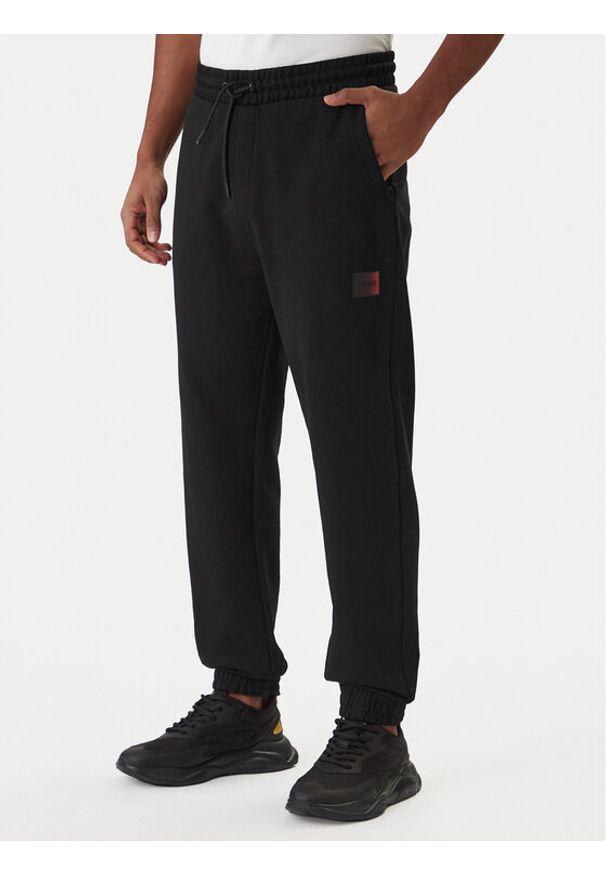 Hugo - HUGO Spodnie dresowe Danopan 50553146 Czarny Relaxed Fit. Kolor: czarny. Materiał: bawełna