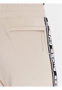 Guess Spodnie dresowe Z2YB19 K6ZS1 Beżowy Regular Fit. Kolor: beżowy. Materiał: dresówka, bawełna