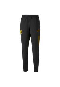 Puma - Spodnie przedmeczowe Manchester City 2022/23. Kolor: wielokolorowy, żółty, czarny. Sport: piłka nożna #1