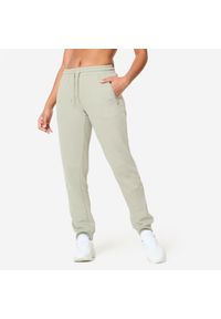 DOMYOS - Spodnie dresowe damskie Domyos Gym & Pilates slim. Kolor: zielony. Materiał: dresówka. Sport: joga i pilates