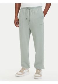 TOMMY HILFIGER - Tommy Hilfiger Spodnie dresowe Essential UM0UM03911 Zielony jasny Relaxed Fit. Kolor: zielony. Materiał: bawełna #1