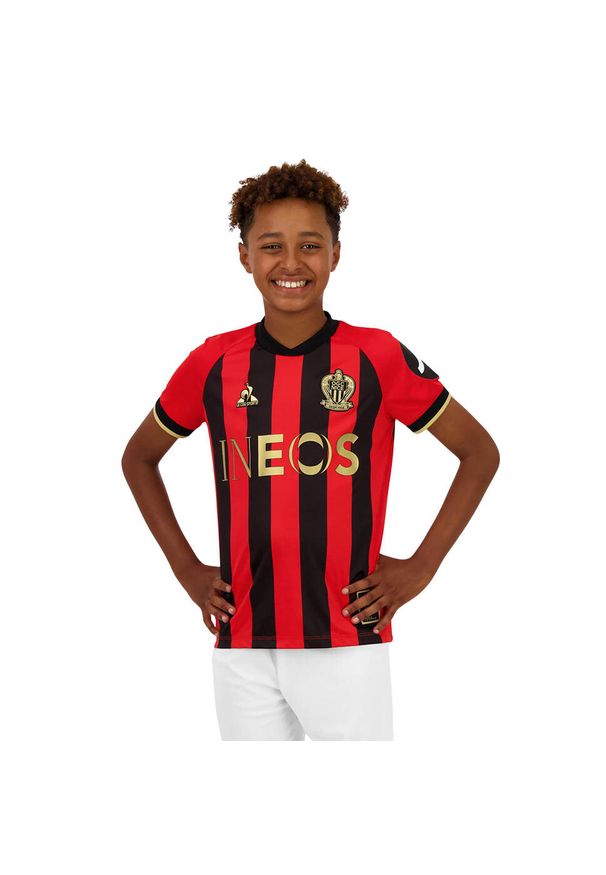 Le Coq Sportif - Koszulka domowa dla dzieci OGC Nice 2024/25. Kolor: czerwony, czarny, wielokolorowy. Sezon: lato. Sport: piłka nożna