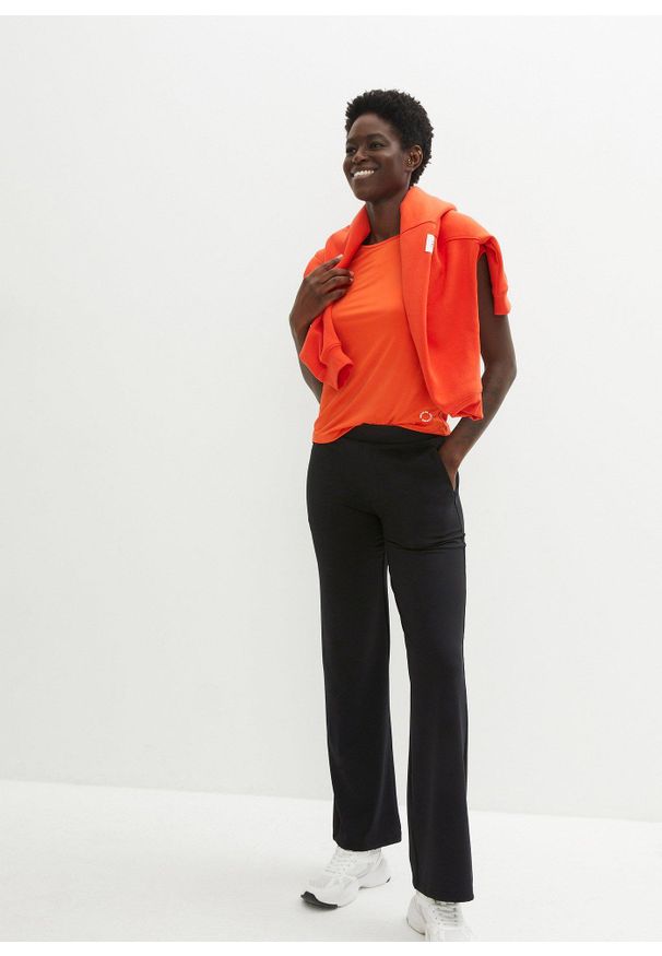 bonprix - Uniwersalne spodnie sportowe z kieszeniami na zamek. Kolor: czarny. Materiał: materiał. Styl: sportowy