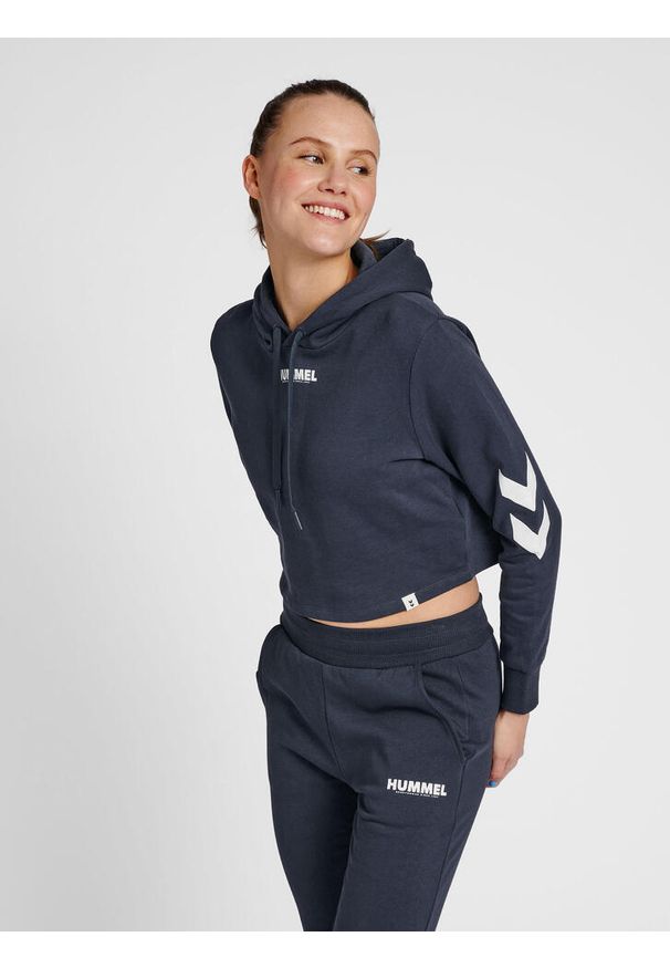 Damska bluza z kapturem crop top Hummel hmlLEGACY. Typ kołnierza: kaptur. Kolor: niebieski, zielony, wielokolorowy. Materiał: materiał, bawełna. Wzór: nadruk. Sport: fitness, piłka ręczna