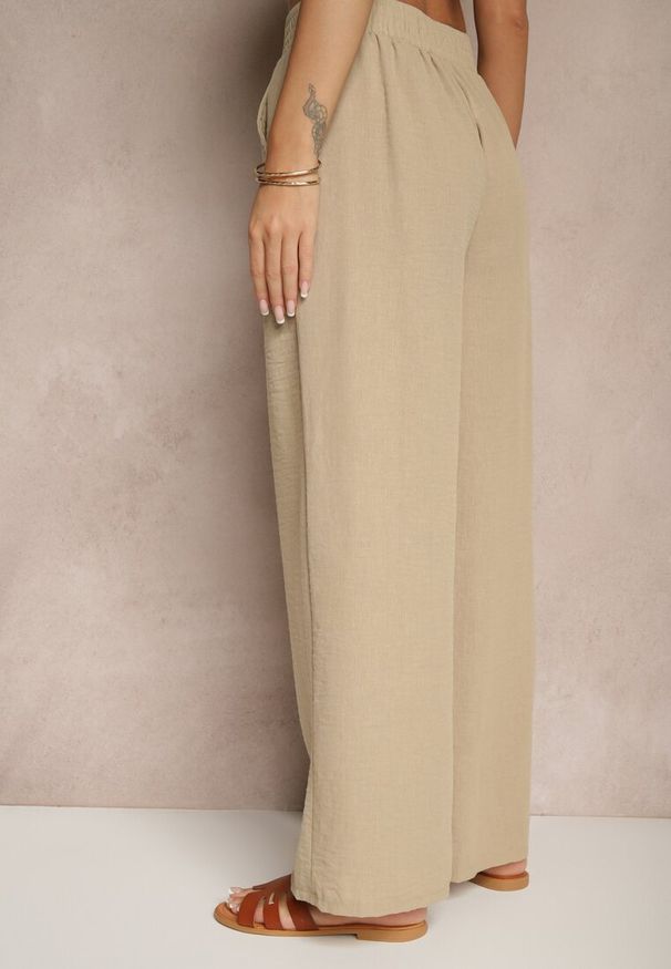 Renee - Beżowe Szerokie Spodnie Palazzo High Waist z Ozdobnym Wiązaniem Arandiel. Okazja: na co dzień. Stan: podwyższony. Kolor: beżowy. Materiał: jedwab. Styl: wizytowy, casual, street