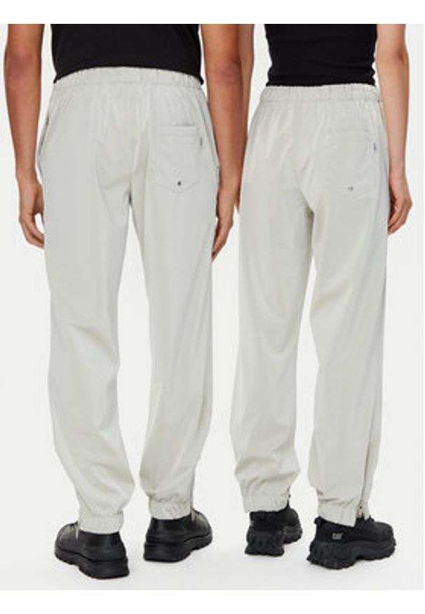 Rains Spodnie przeciwdeszczowe Unisex 18560 Beżowy Regular Fit. Kolor: beżowy. Materiał: syntetyk