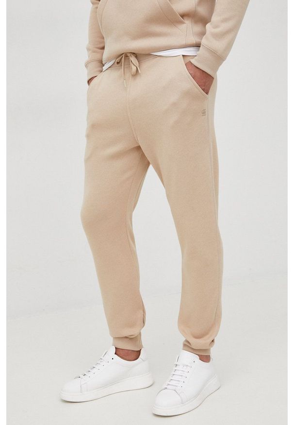 G-Star RAW - G-Star Raw spodnie męskie gładkie. Kolor: beżowy. Materiał: poliester. Wzór: gładki
