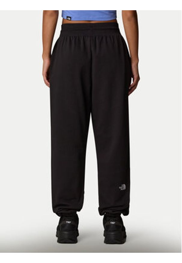 The North Face Spodnie dresowe Essential NF0A8C1G Czarny Relaxed Fit. Kolor: czarny. Materiał: syntetyk, bawełna