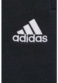 Adidas - adidas spodnie damskie kolor czarny z aplikacją. Stan: podwyższony. Kolor: czarny. Materiał: materiał, bawełna, dzianina. Wzór: aplikacja
